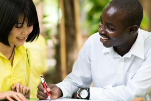 Young adult doing homework with peer