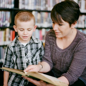 Adult reading a book to child
