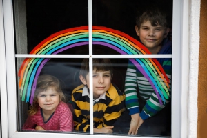 Three children looking out window